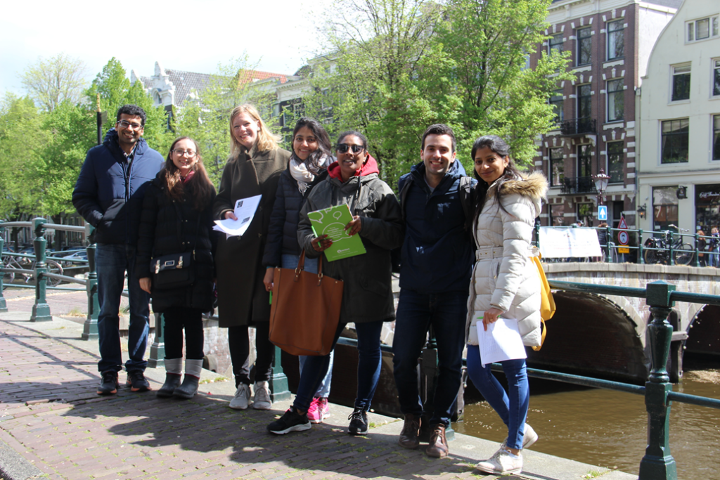 Koentact students in the center of Amsterdam, posing next to a canal